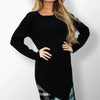 Elegant knee-length dress with black and white accents.