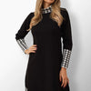 Timi knit dress with white plaid pattern in black.